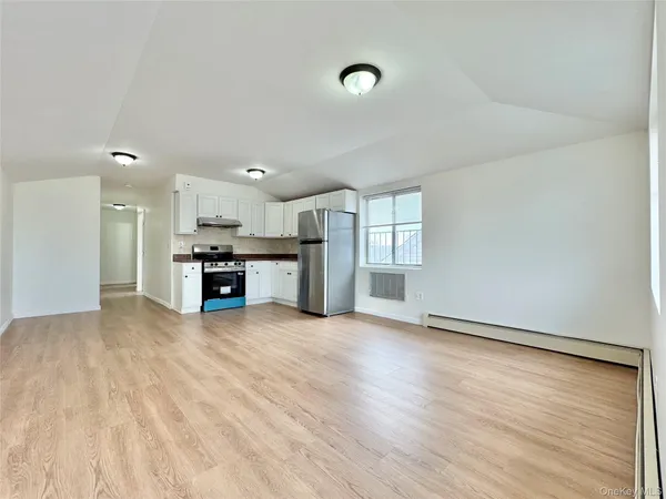 a view of kitchen with stainless steel appliances kitchen island wooden floor and window