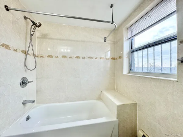 a bathroom with a bath tub with a shower