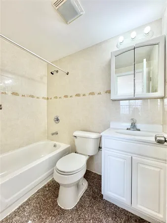 a bathroom with a sink toilet vanity and bathtub