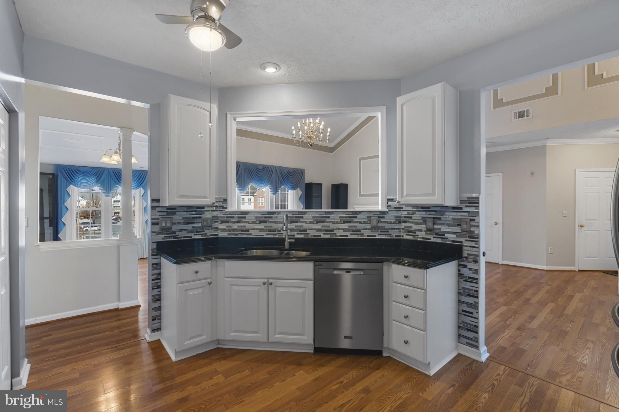 4868 Brightleaf Court, Unit 4868 Rosedale, MD 21237 - Photo 11 of 25 a kitchen with granite countertop a sink cabinets and wooden floor