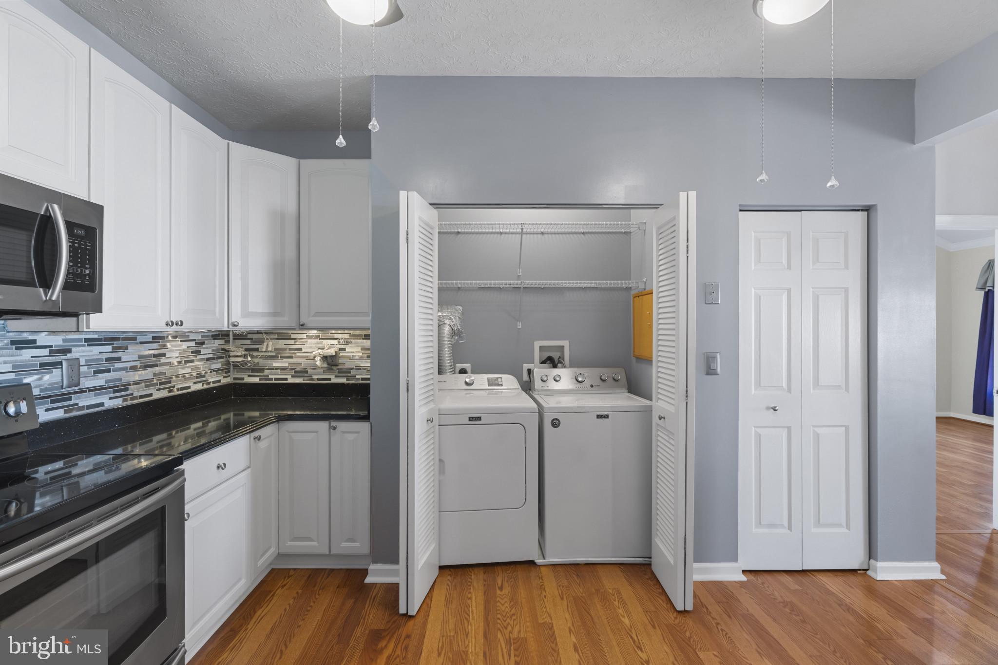 4868 Brightleaf Court, Unit 4868 Rosedale, MD 21237 - Photo 12 of 25 a kitchen with appliances cabinets and wooden floor