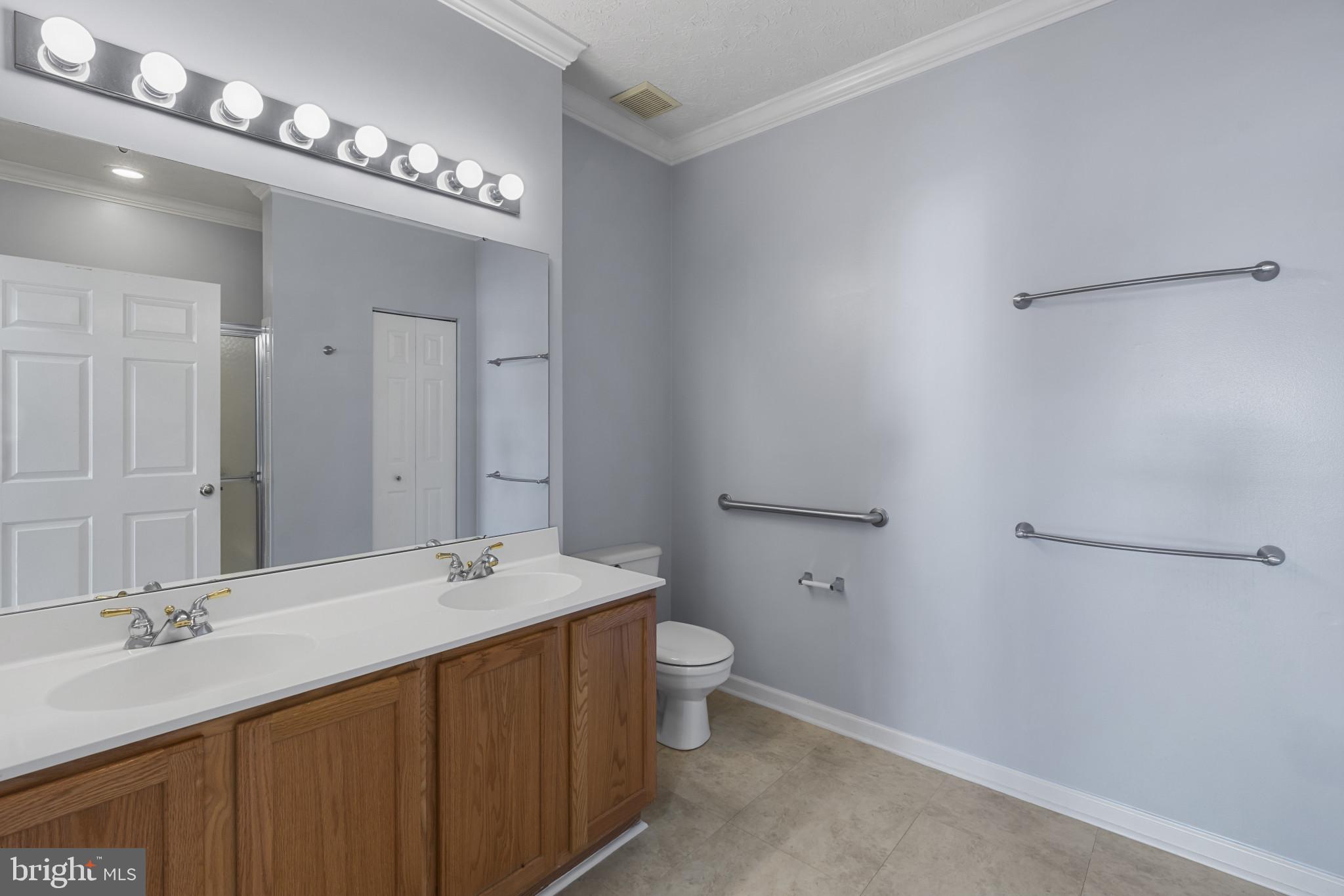 4868 Brightleaf Court, Unit 4868 Rosedale, MD 21237 - Photo 16 of 25 a bathroom with a double vanity sink and a mirror
