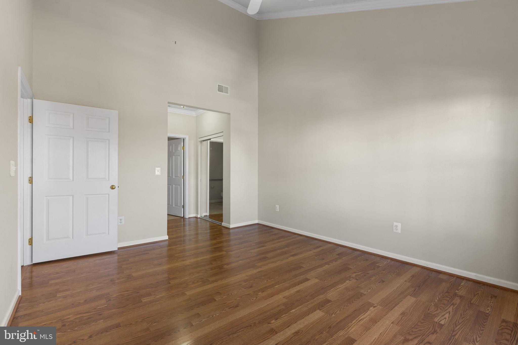 4868 Brightleaf Court, Unit 4868 Rosedale, MD 21237 - Photo 19 of 25 a view of an empty room with wooden floor and a window