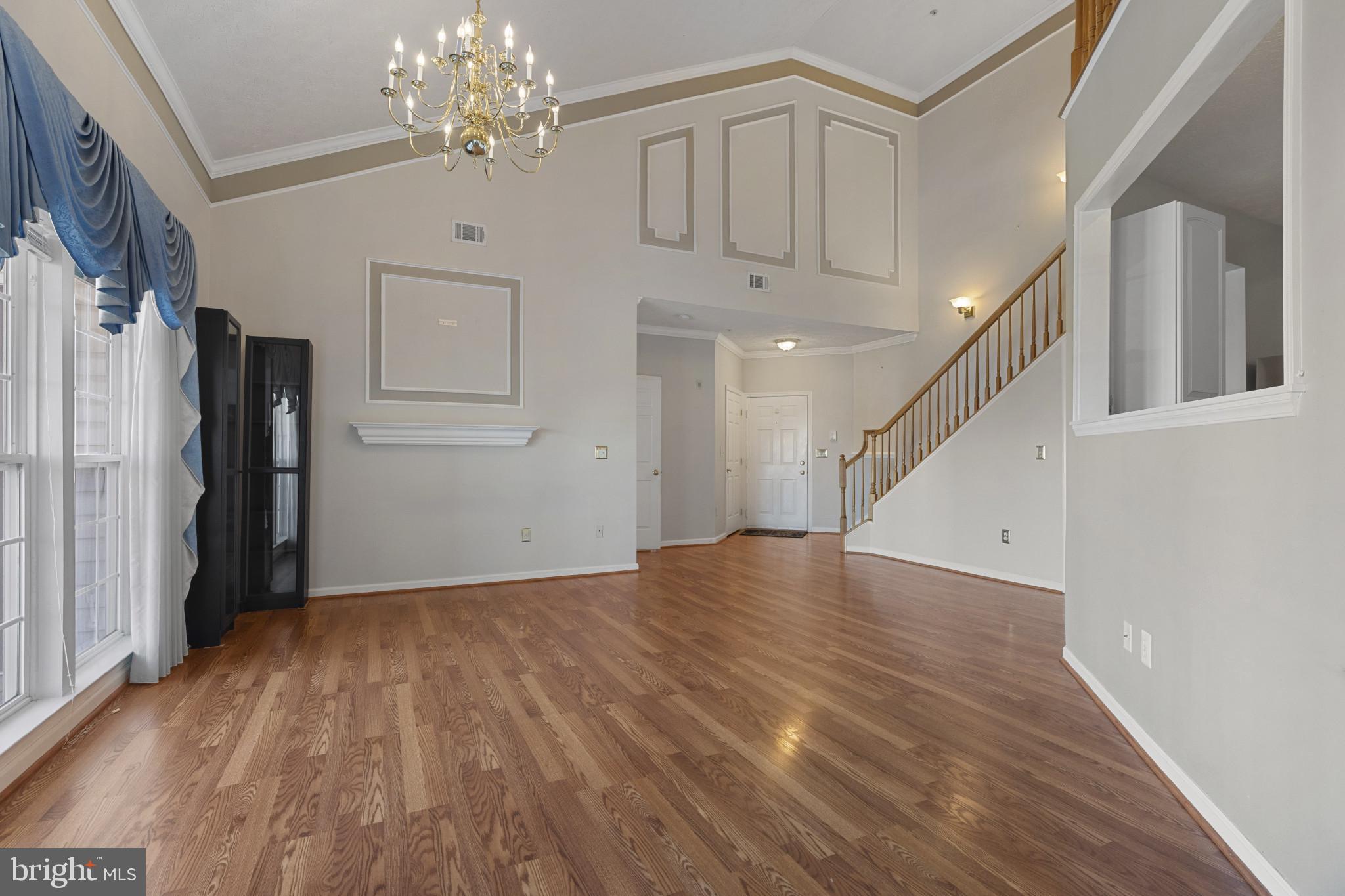 4868 Brightleaf Court, Unit 4868 Rosedale, MD 21237 - Photo 2 of 25 a view of an empty room with wooden floor and a window