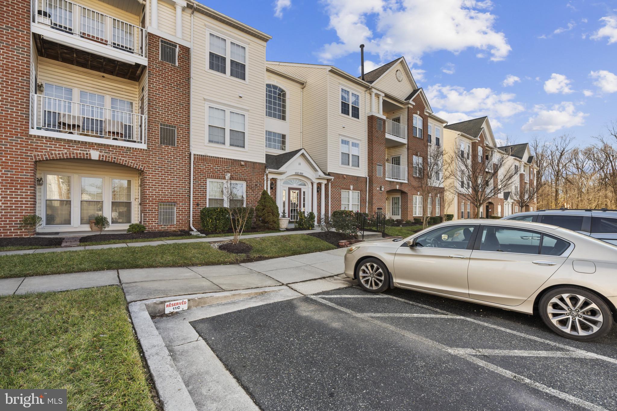4868 Brightleaf Court, Unit 4868 Rosedale, MD 21237 - Photo 24 of 25 a view of a car parked in front of a brick house
