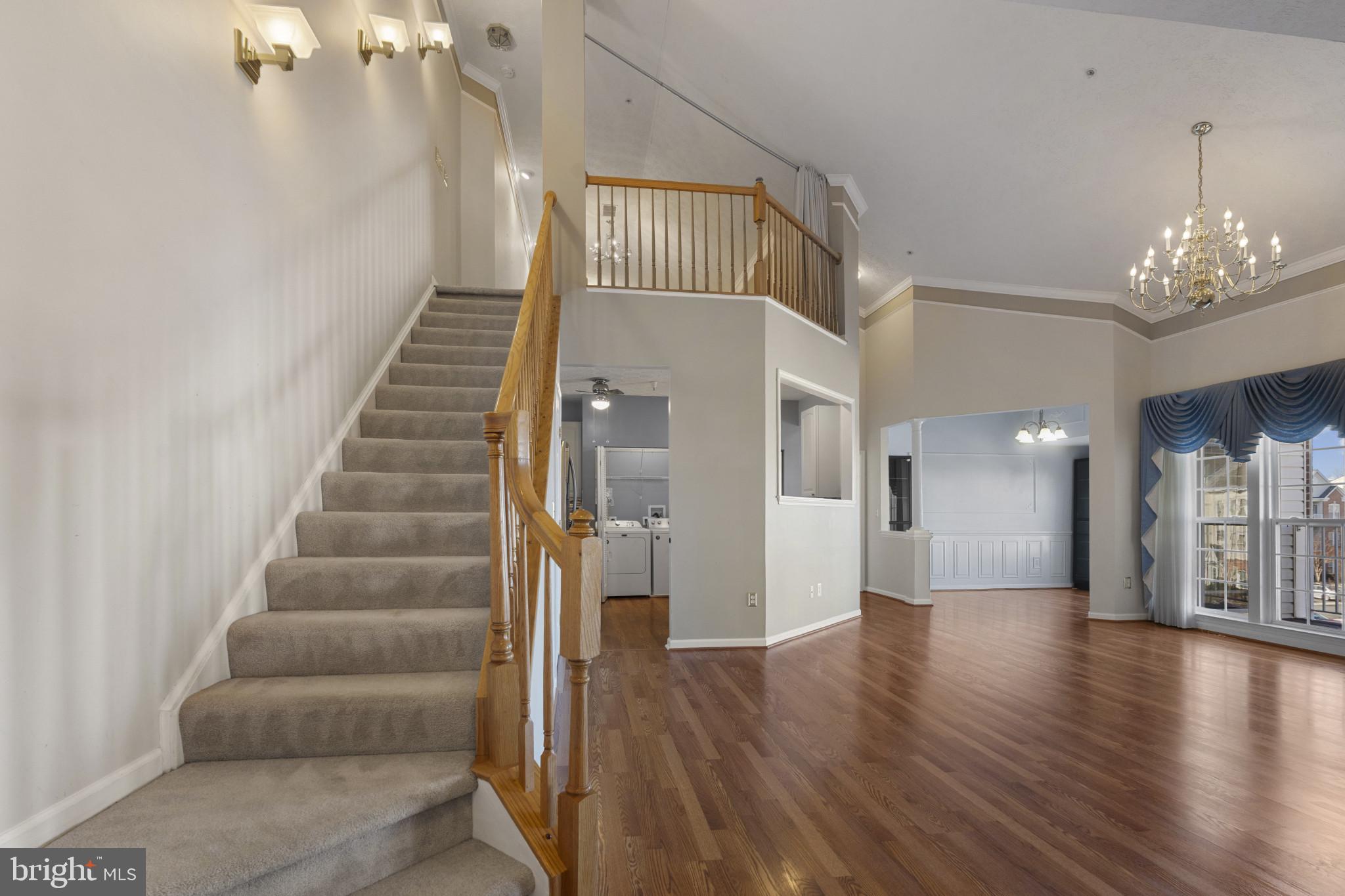 4868 Brightleaf Court, Unit 4868 Rosedale, MD 21237 - Photo 4 of 25 a view of a hallway with wooden floor and staircase