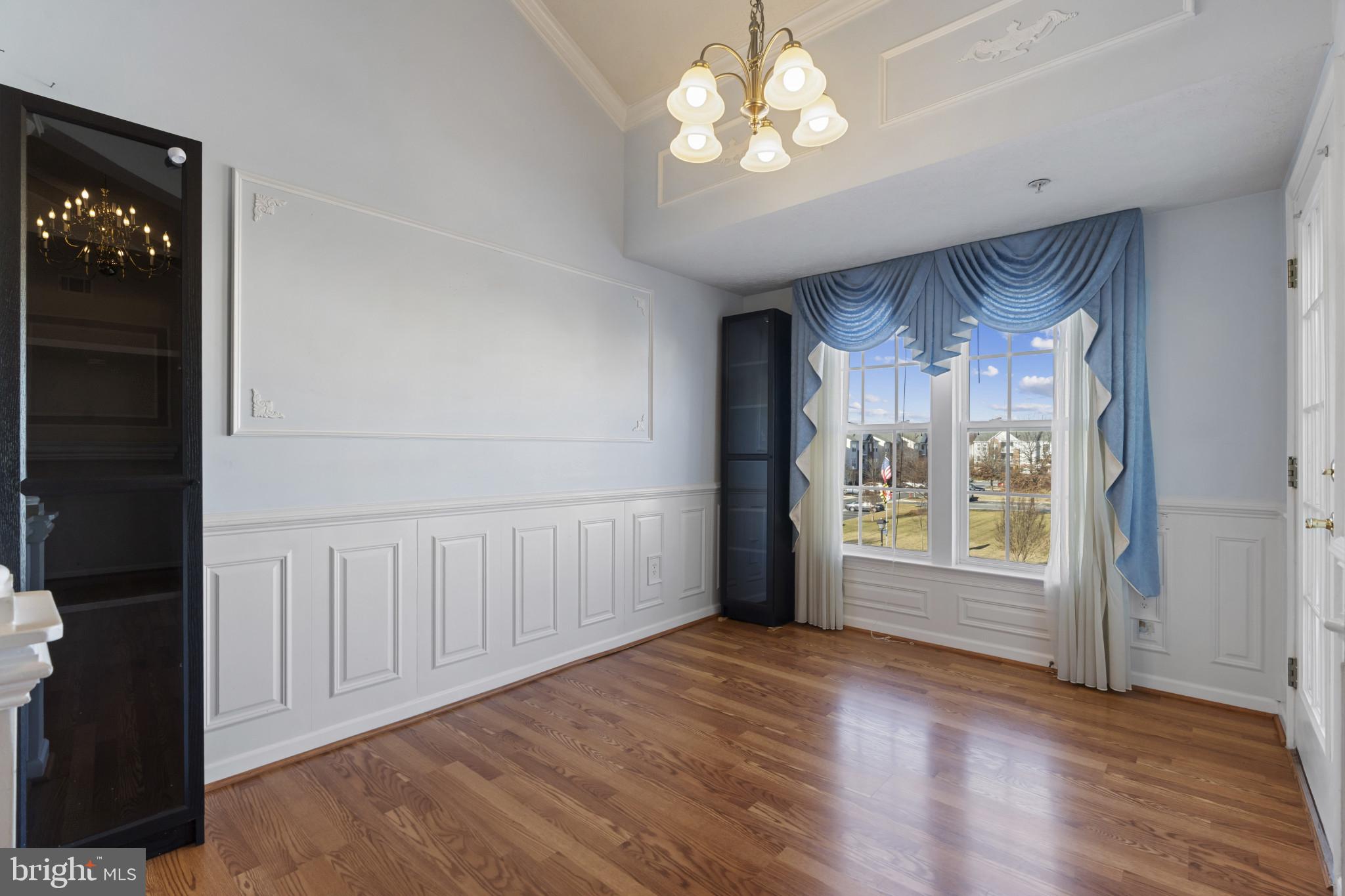 4868 Brightleaf Court, Unit 4868 Rosedale, MD 21237 - Photo 7 of 25 a view of an empty room with a window and wooden floor