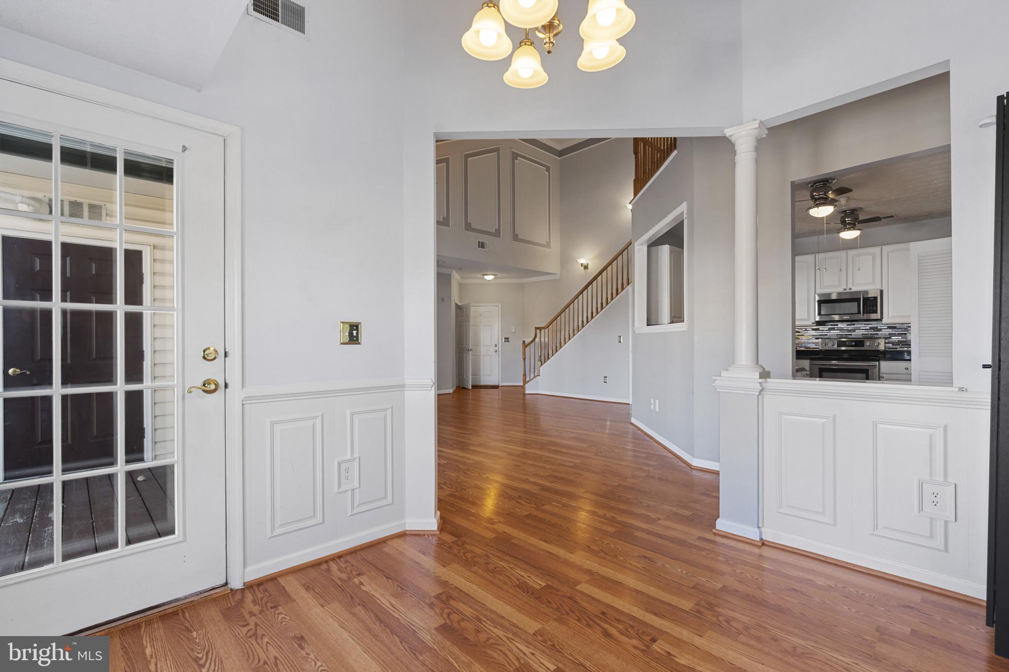 4868 Brightleaf Court, Unit 4868 Rosedale, MD 21237 - Photo 8 of 25 a view of a hallway with wooden floor and staircase
