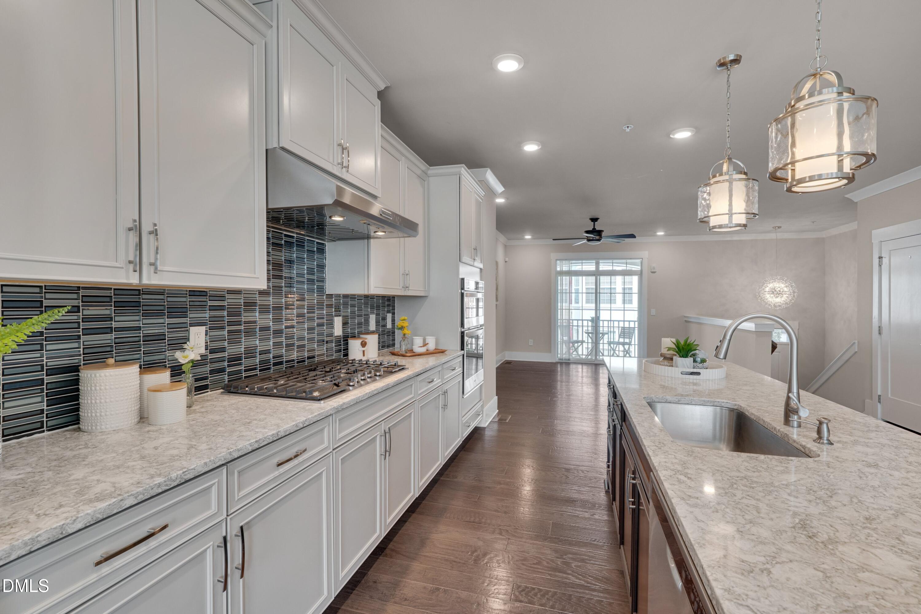10330 Sablewood Drive, Unit 104 Raleigh, NC 27617 - Photo 6 of 28 a large kitchen with stainless steel appliances lots of counter space and a sink