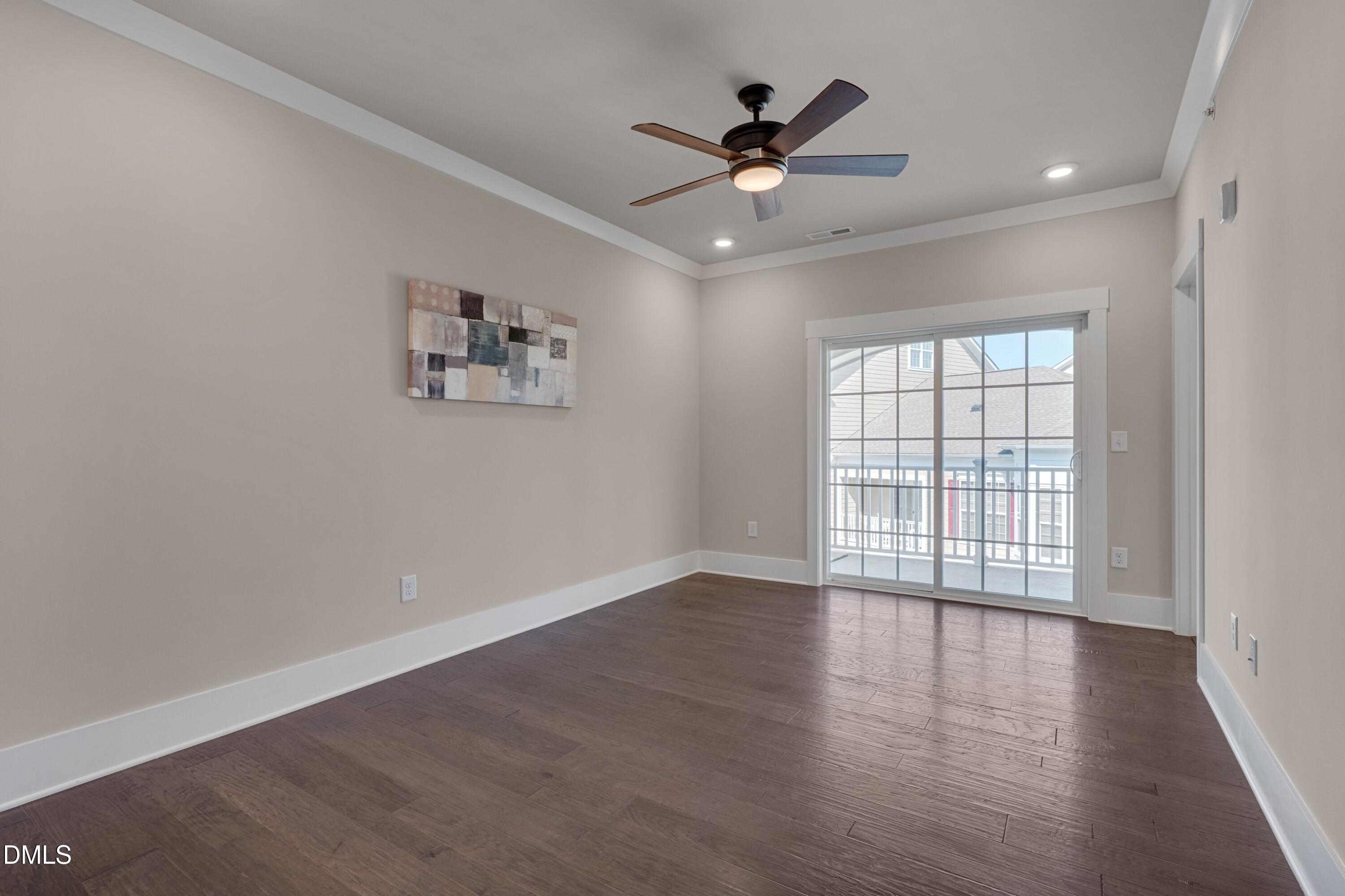 10330 Sablewood Drive, Unit 104 Raleigh, NC 27617 - Photo 9 of 28 wooden floor in an empty room with a window