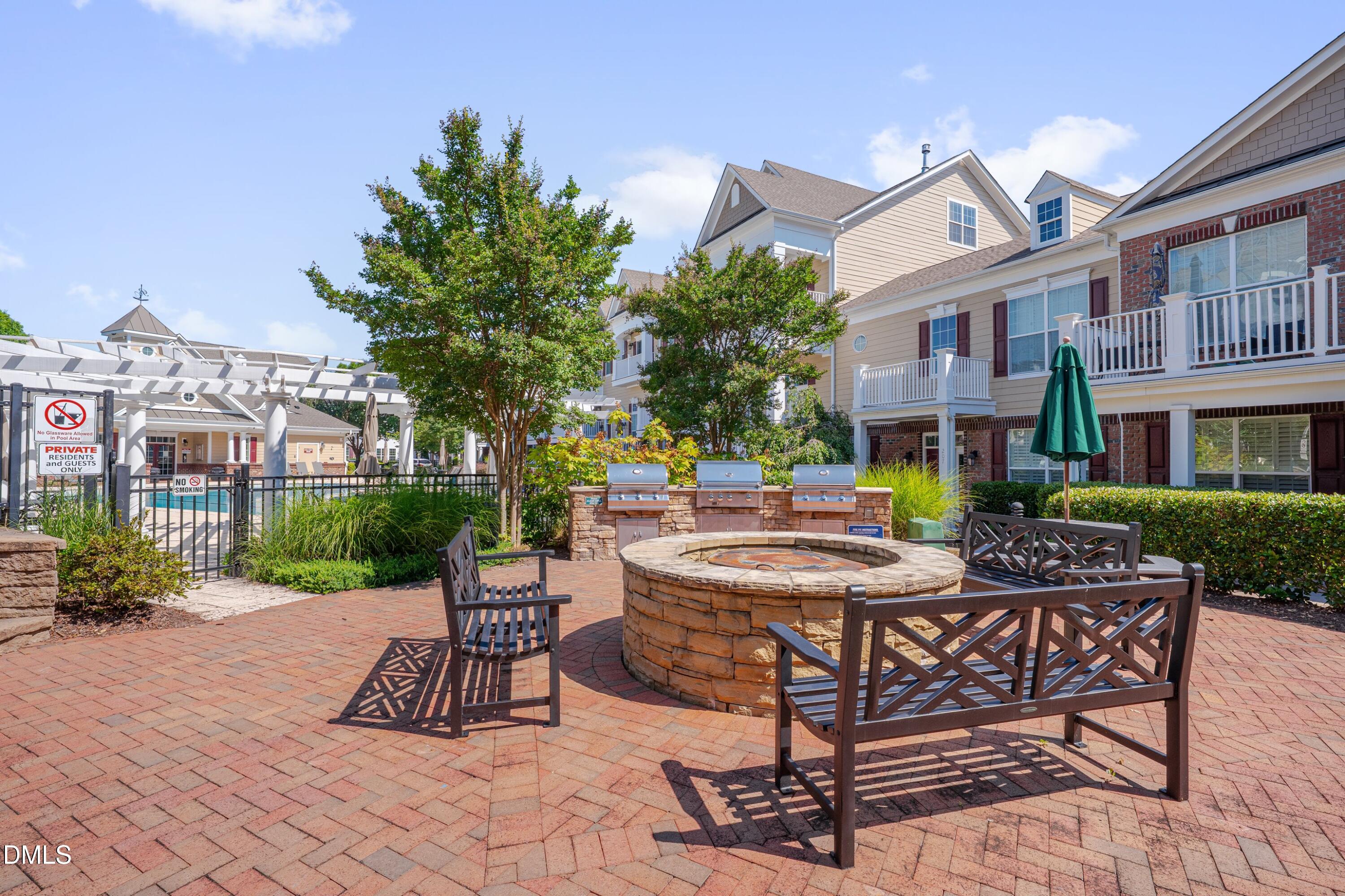10330 Sablewood Drive, Unit 104 Raleigh, NC 27617 - Photo 21 of 28 a view of a patio with table and chairs and potted plants