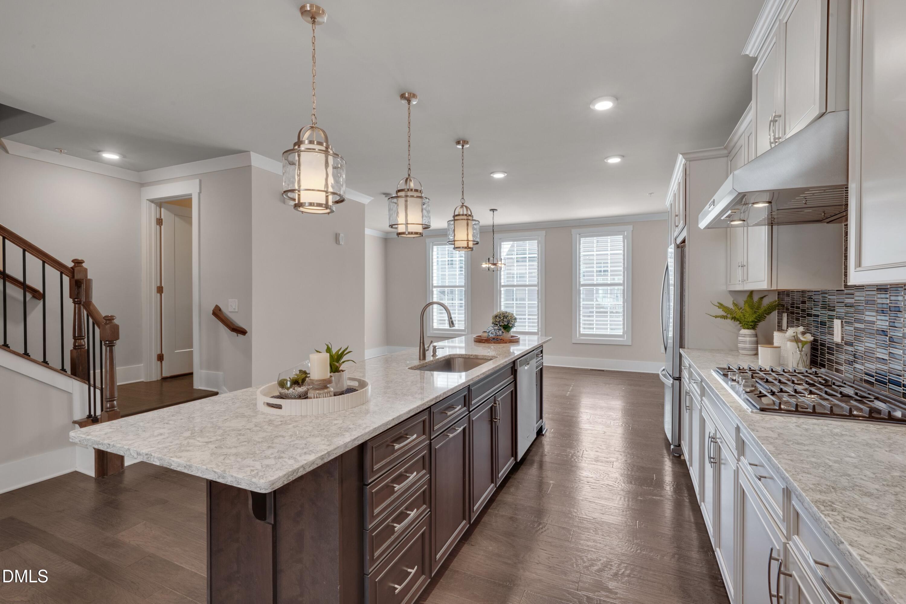 10330 Sablewood Drive, Unit 104 Raleigh, NC 27617 - Photo 4 of 28 a large kitchen with kitchen island a large island in it