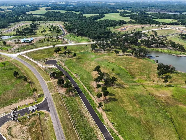 an aerial view of a residential houses with outdoor space