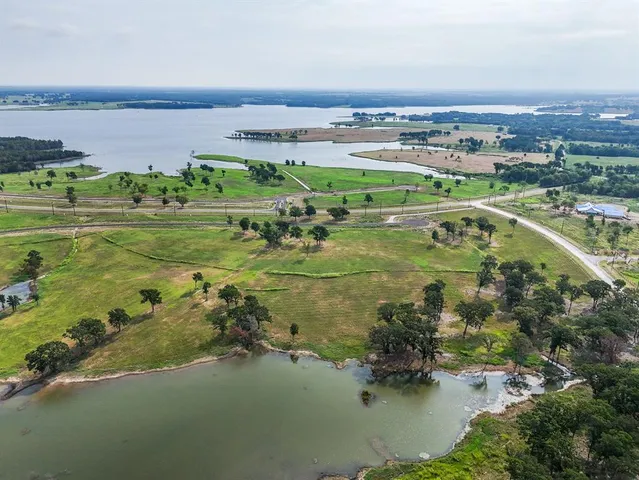 an aerial view of a residential houses with outdoor space