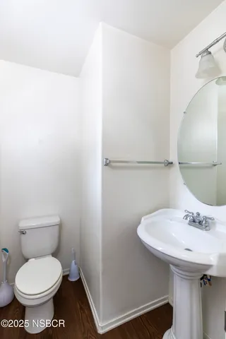 a view of a hallway with bathroom and a shower