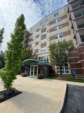 a front view of a building with a garden