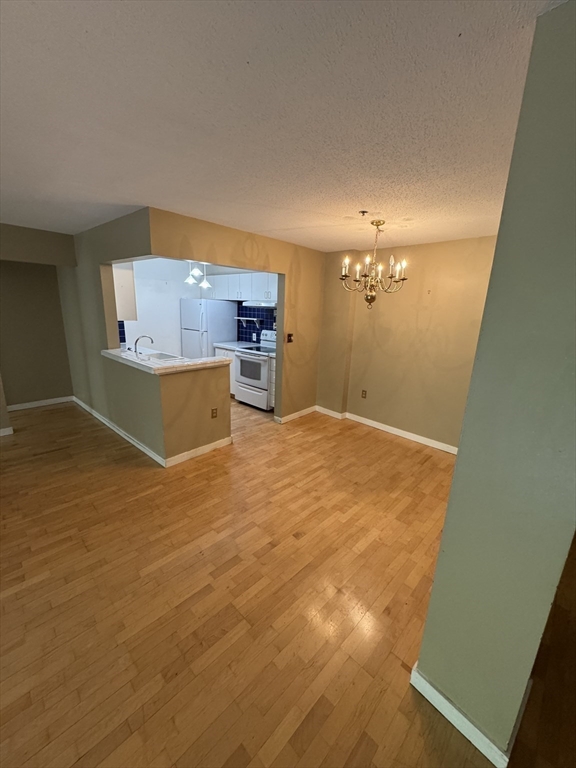 273 Cambridge Road, Unit 202 Woburn, MA 01801 - Photo 19 of 38 a view of a room with a kitchen