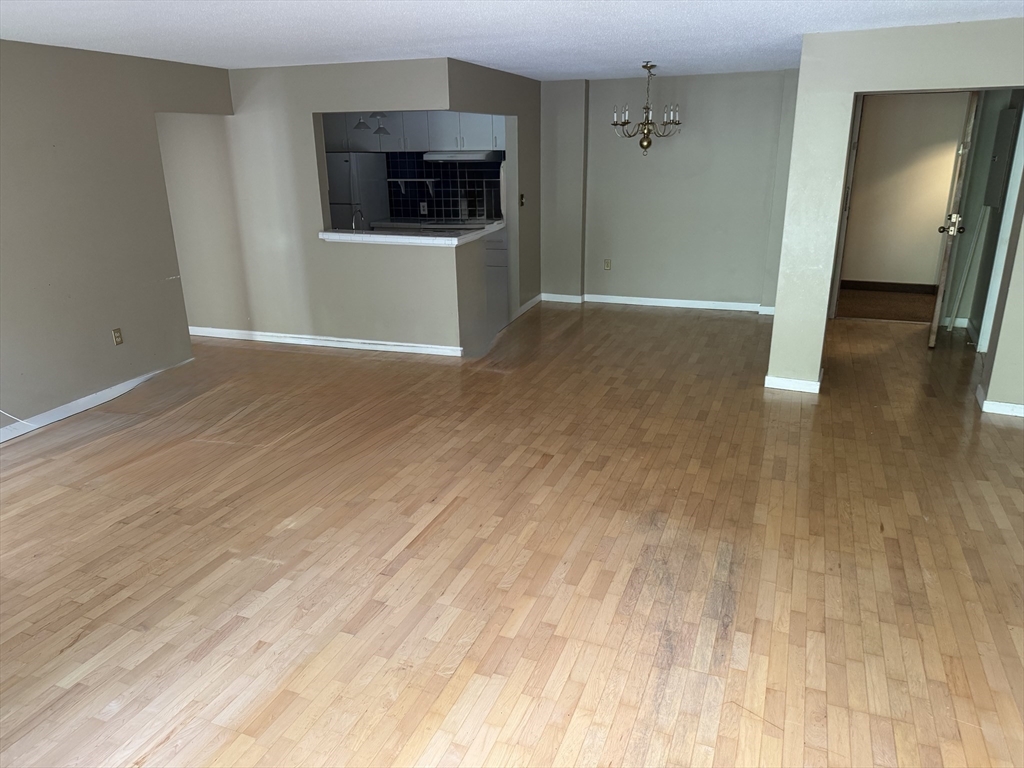 273 Cambridge Road, Unit 202 Woburn, MA 01801 - Photo 20 of 38 a view of a kitchen from the hallway