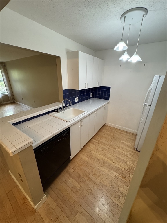 273 Cambridge Road, Unit 202 Woburn, MA 01801 - Photo 23 of 38 a bathroom with a sink and a mirror