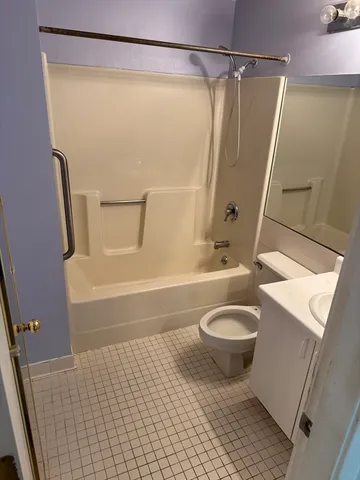 a bathroom with a shower and a toilet