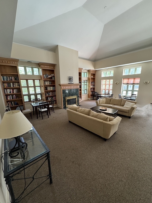 273 Cambridge Road, Unit 202 Woburn, MA 01801 - Photo 34 of 38 a living room with furniture and a large window