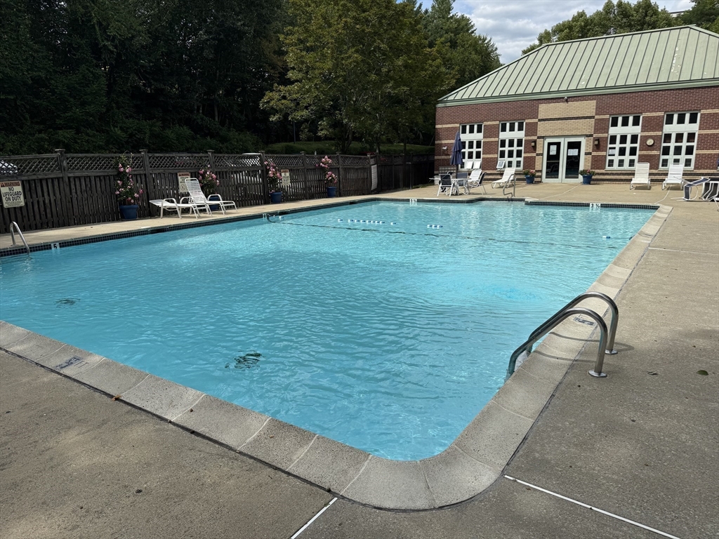 273 Cambridge Road, Unit 202 Woburn, MA 01801 - Photo 36 of 38 a view of a house with a swimming pool and sitting area