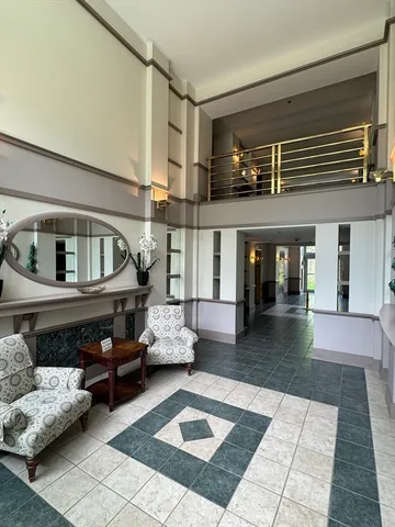 a living room with furniture and stairs