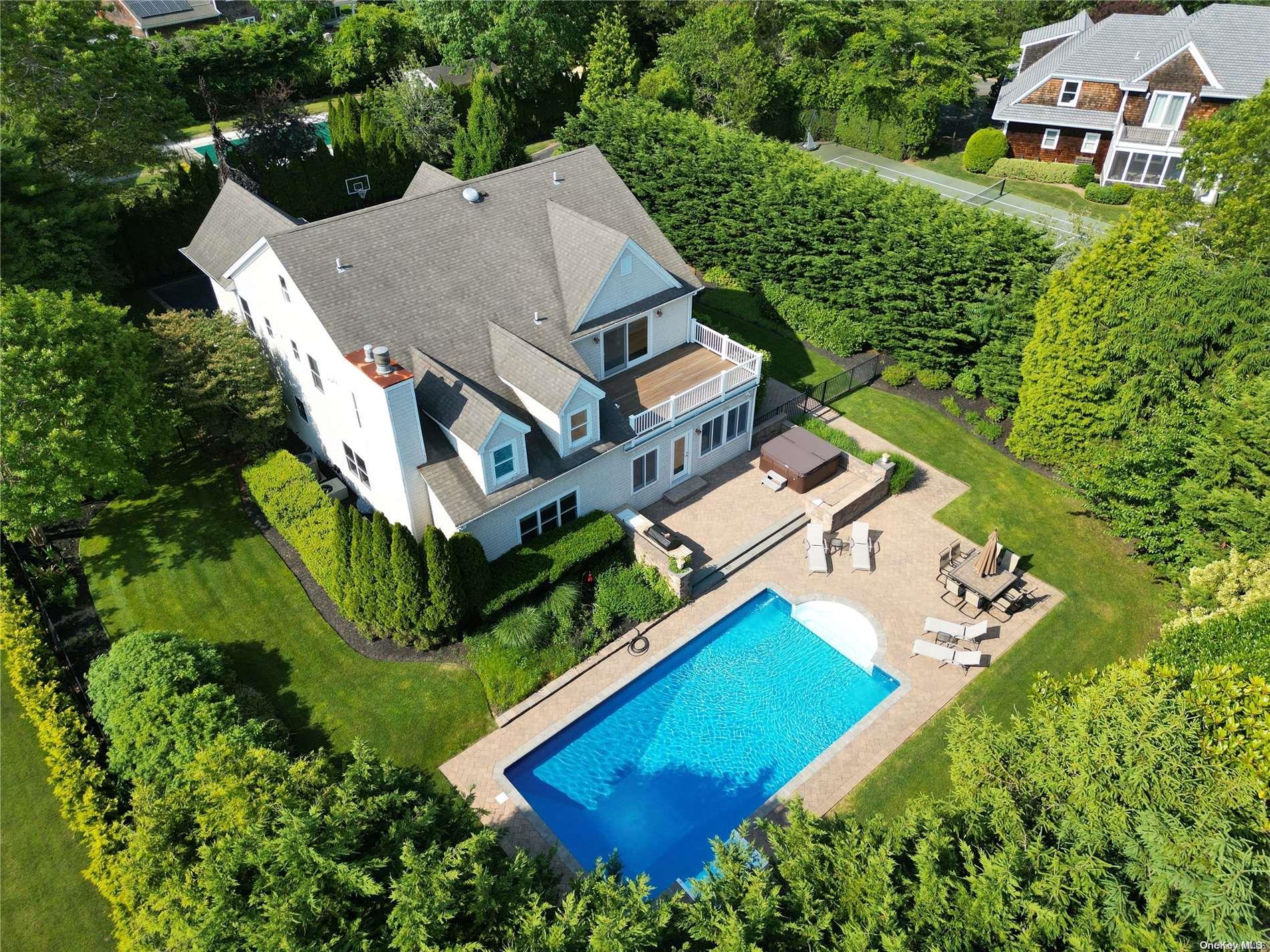 an aerial view of residential house with outdoor space and swimming pool