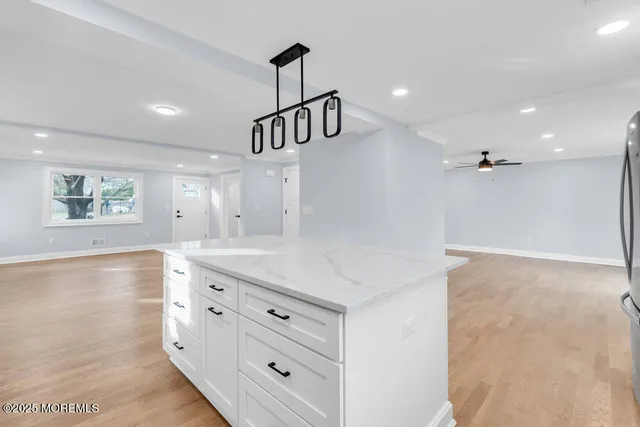 a kitchen with stainless steel appliances a stove a sink a refrigerator and cabinets