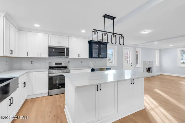 a kitchen with stainless steel appliances a stove a sink and a microwave