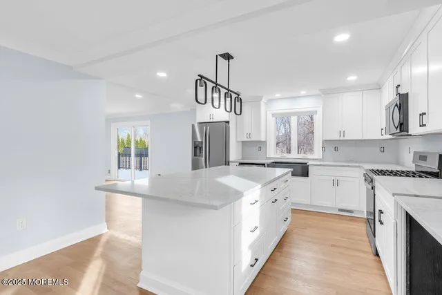 a view of a kitchen with a sink and a window