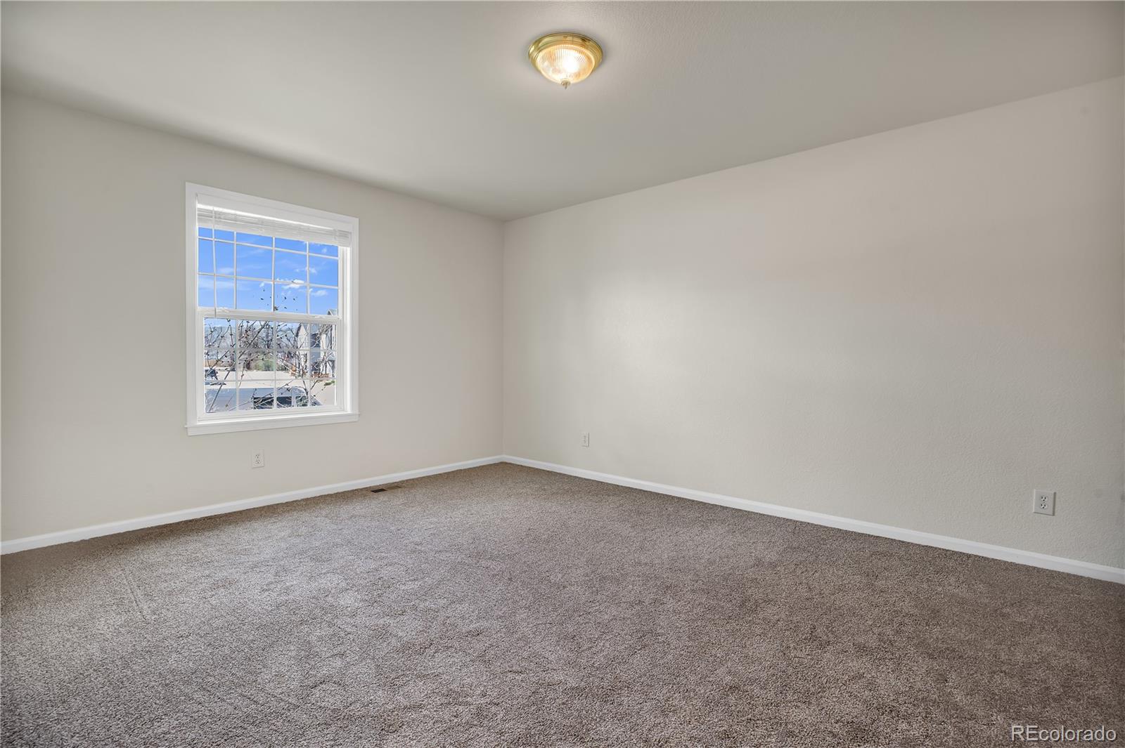 4505 Simms Court Wheat Ridge, CO 80033 - Photo 27 of 37 a view of an empty room with a window