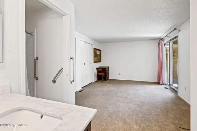 an empty room with furniture and a fireplace