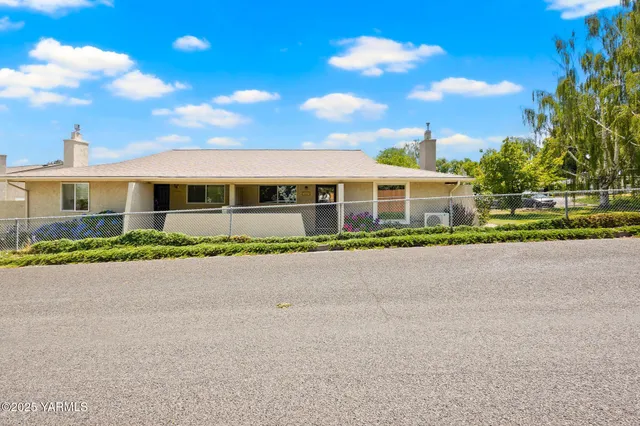 front view of a house with a garden