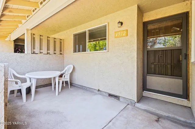 an empty room with windows and fireplace