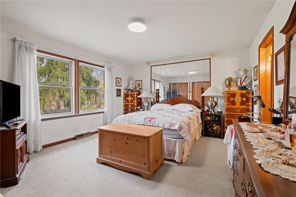 2997 Spangler Road Hermitage, PA 16148 - Photo 12 of 43 a bedroom with a bed and a flat tv screen on dresser