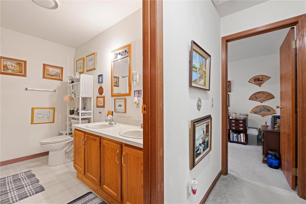 2997 Spangler Road Hermitage, PA 16148 - Photo 15 of 43 a bathroom with a sink a toilet and a large mirror
