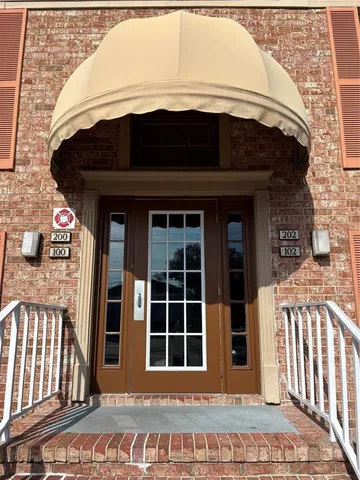 a view of a house with a door and a rug