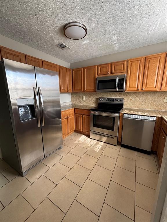 404 Banyon Tree Circle, Unit 200 Maitland, FL 32751 - Photo 2 of 11 a kitchen with stainless steel appliances granite countertop a refrigerator and a stove top oven