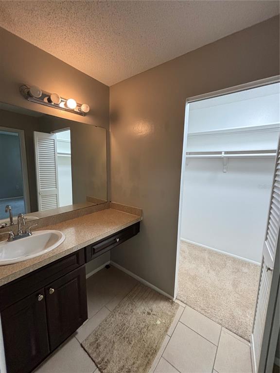 404 Banyon Tree Circle, Unit 200 Maitland, FL 32751 - Photo 9 of 11 a bathroom with a sink and a mirror