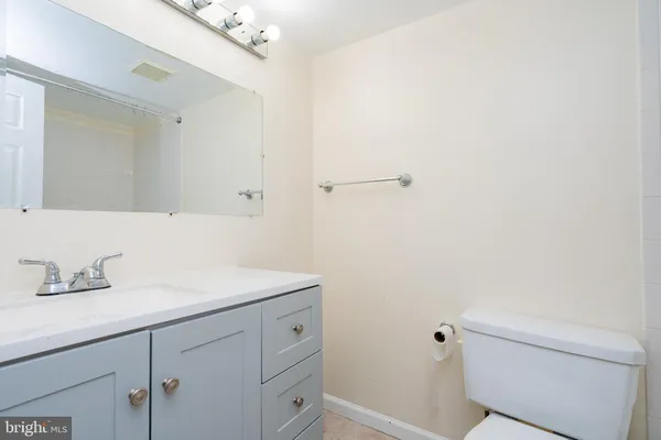 a bathroom with a sink vanity and mirror
