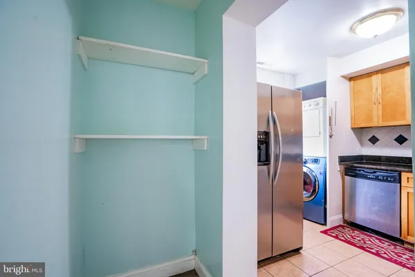 a kitchen with stainless steel appliances granite countertop a stove and a refrigerator