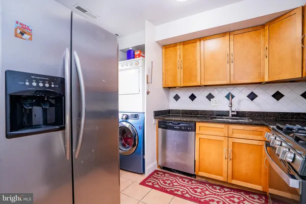 a kitchen with stainless steel appliances granite countertop a stove and a microwave