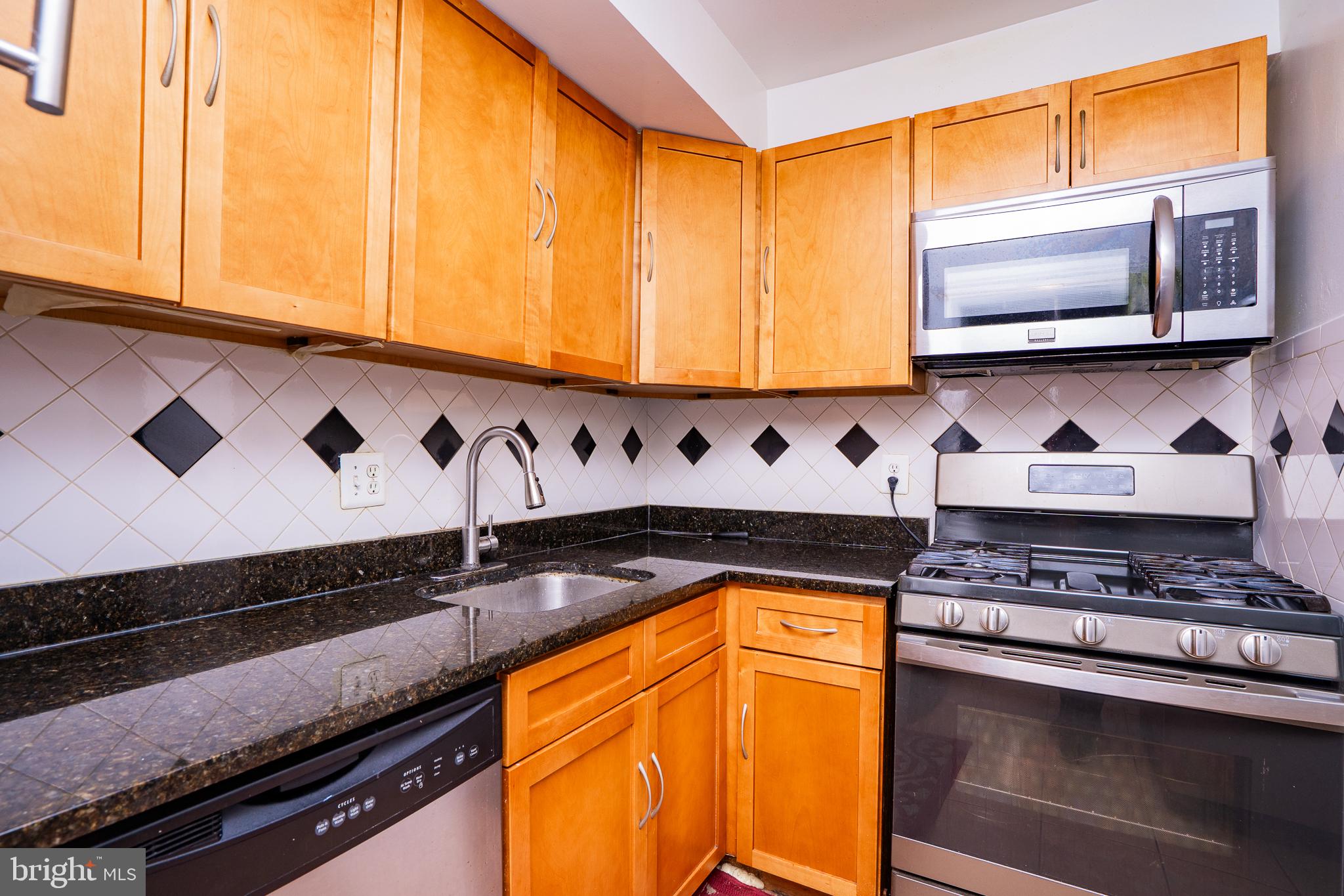 3960 Bel Pre Road, Unit 1 Silver Spring, MD 20906 - Photo 24 of 33 Modern kitchen with sleek finishes.