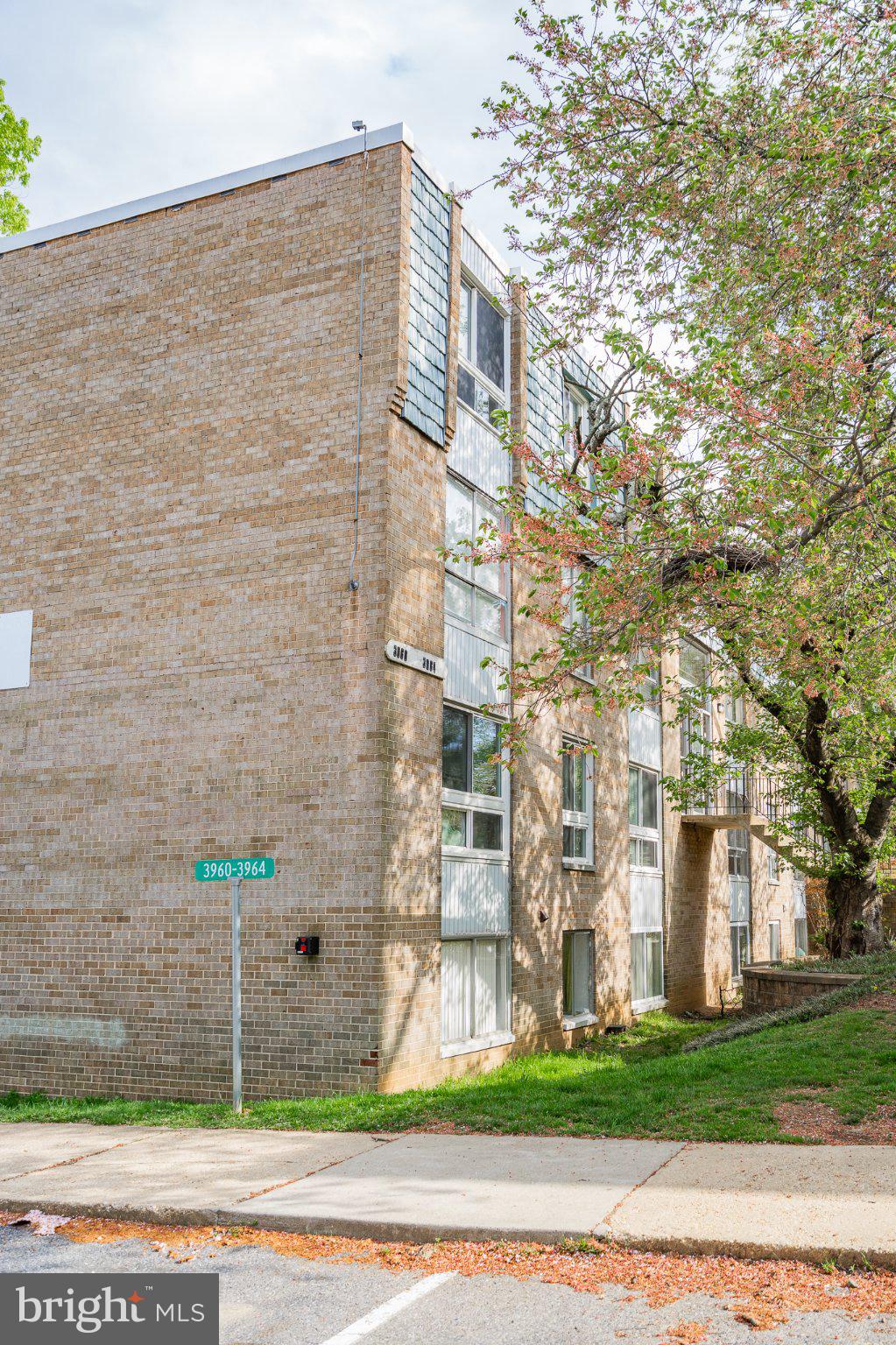 3960 Bel Pre Road, Unit 1 Silver Spring, MD 20906 - Photo 4 of 33 Modern brick facade with lush greenery.