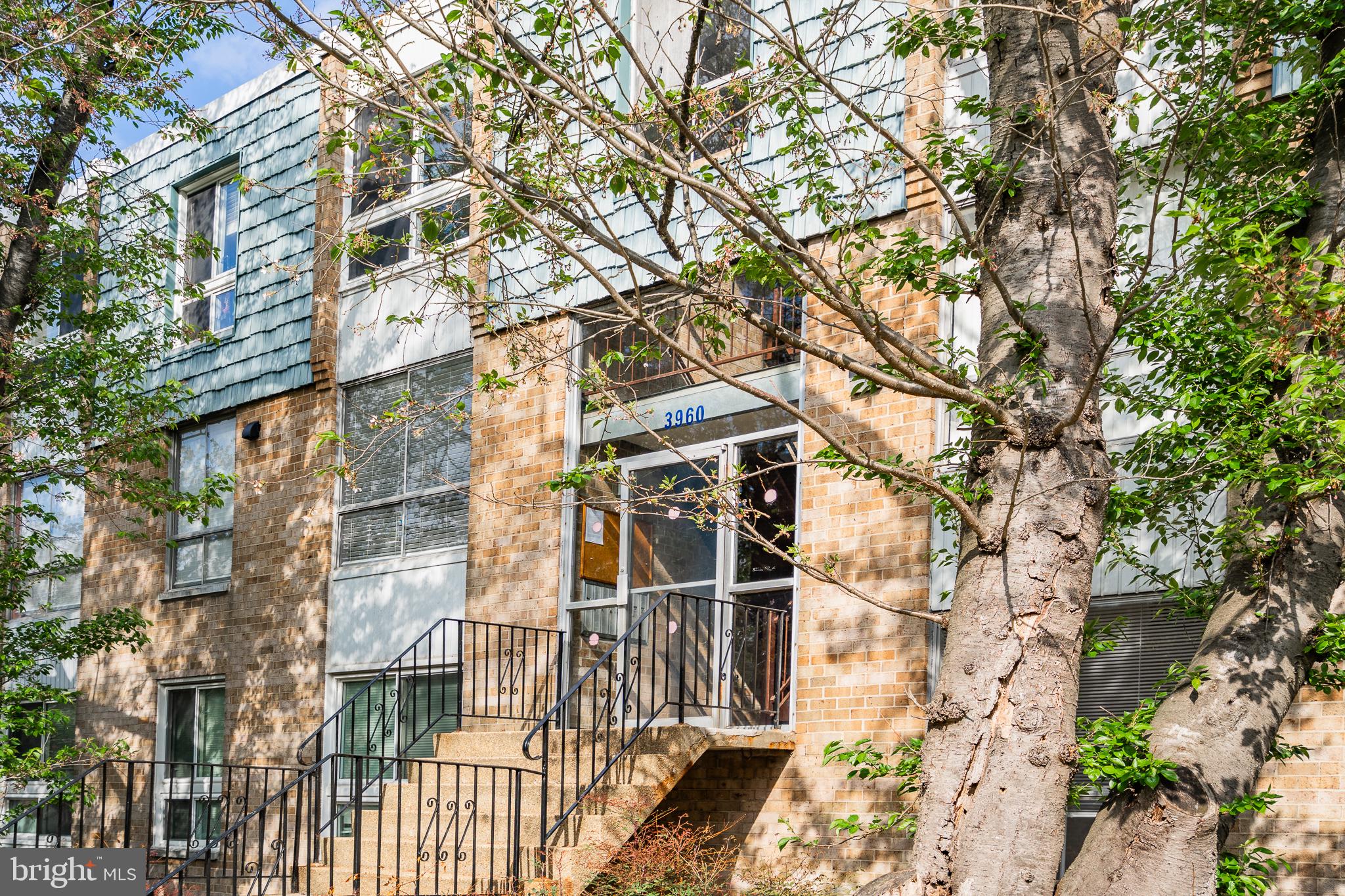 3960 Bel Pre Road, Unit 1 Silver Spring, MD 20906 - Photo 6 of 33 Charming brick facade with lush greenery.