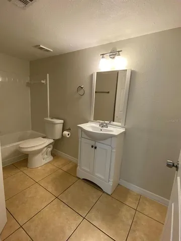 a bathroom with a sink toilet and mirror