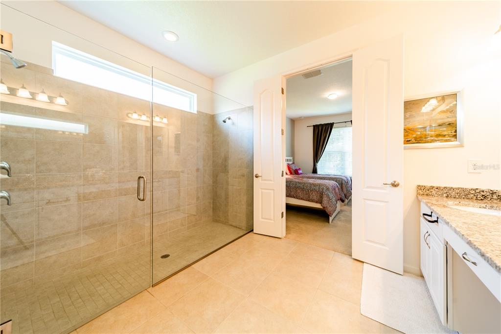 4027 Oakrise Loop Davenport, FL 33837 - Photo 36 of 66 a en suite bathroom with a shower