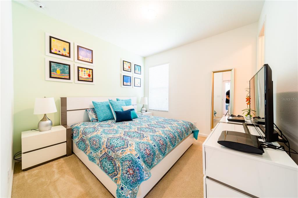 4027 Oakrise Loop Davenport, FL 33837 - Photo 45 of 66 a bedroom with a bed and a couch