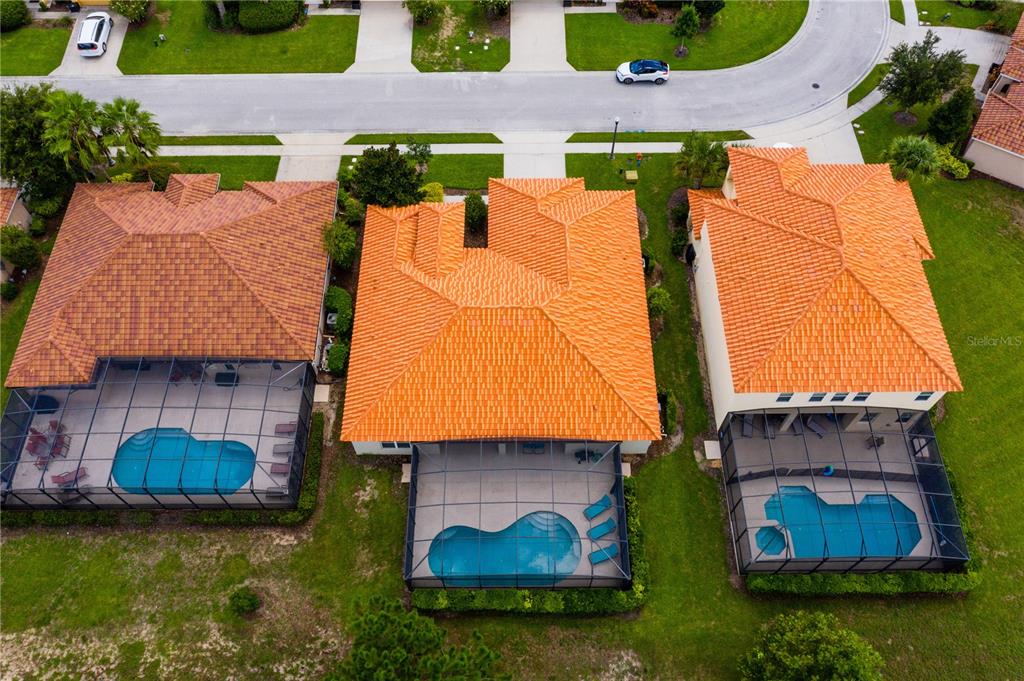 4027 Oakrise Loop Davenport, FL 33837 - Photo 63 of 66 an aerial view of a house with a garden and swimming pool